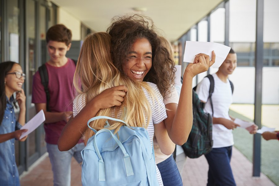 Students celebrating together in a school hallway